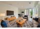 Comfortable living room with modern furnishings, a patterned rug, and lots of natural light at 290 2Nd St, Fayetteville, GA 30214