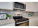 Kitchen detail showing stainless steel range and microwave at 4505 Ajo Walk, Atlanta, GA 30331