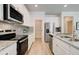 Modern kitchen featuring stainless steel appliances and light gray tile backsplash at 4505 Ajo Walk, Atlanta, GA 30331