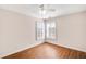 Bright bedroom with hardwood floors, a ceiling fan, and shuttered windows at 120 Mill Creek Dr, Canton, GA 30115