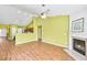 Bright living room with a fireplace, hardwood floors, and modern ceiling fan at 120 Mill Creek Dr, Canton, GA 30115