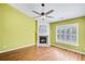 Cozy living room with a fireplace and a large window with plantation shutters at 120 Mill Creek Dr, Canton, GA 30115