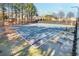 Outdoor community tennis court with benches surrounded by mature trees at 120 Mill Creek Dr, Canton, GA 30115