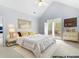 Bright bedroom boasts vaulted ceilings, shutters, and stylish, modern gold and white furniture at 500 Meadowmeade Ln, Lawrenceville, GA 30043