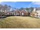 Brick home with a large front yard and mature trees at 500 Meadowmeade Ln, Lawrenceville, GA 30043