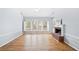 Living room featuring a brick fireplace, vaulted ceilings, lots of windows, and hardwood floors at 500 Meadowmeade Ln, Lawrenceville, GA 30043