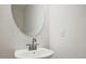 Modern bathroom with a stylish vanity, oval mirror, and sleek faucet at 697 Sunstone Ln, Lawrenceville, GA 30043