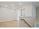 Hallway with hardwood floors and natural light leading to additional rooms at 697 Sunstone Ln, Lawrenceville, GA 30043