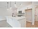 Kitchen with white cabinets, stainless steel appliances, a large island, and sleek fixtures creates a modern look at 697 Sunstone Ln, Lawrenceville, GA 30043
