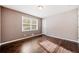 Comfortable bedroom with hardwood floors, natural light, and neutral color scheme at 1085 Azalea Cir, Marietta, GA 30062