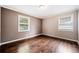 Bright bedroom features hardwood floors, neutral paint, and natural light from two windows at 1085 Azalea Cir, Marietta, GA 30062