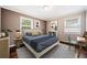 Stylish bedroom featuring a comfortable bed, area rug, and a side table with desk at 1085 Azalea Cir, Marietta, GA 30062