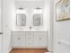 Double vanity bathroom with white cabinets and rectangular mirrors at 2048 Chicago Nw Ave, Atlanta, GA 30314