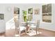 Bright dining area with glass table and four upholstered chairs at 2048 Chicago Nw Ave, Atlanta, GA 30314