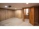 Spacious basement area featuring paneled walls, tile flooring, and access to stairs leading to another level at 4771 Cool Springs Rd, Winston, GA 30187