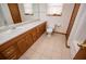 Well-lit bathroom featuring a long vanity with sink, toilet, and tile flooring at 4771 Cool Springs Rd, Winston, GA 30187