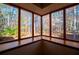 Cozy sunroom nook featuring a large bay window overlooking the surrounding woods at 4771 Cool Springs Rd, Winston, GA 30187