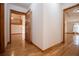 Hallway featuring hardwood floors and wood trim, leading to other rooms at 4771 Cool Springs Rd, Winston, GA 30187