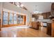 Sun-filled kitchen with wood cabinets, white appliances, and hardwood floors at 4771 Cool Springs Rd, Winston, GA 30187