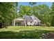 Spacious backyard featuring a well-maintained lawn, a deck, and a convenient carport at 291 Miquel Jorge Ln, Canton, GA 30115