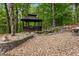 Outdoor gazebo with stone patio, complemented by a tranquil pond and waterfall feature in a private backyard at 291 Miquel Jorge Ln, Canton, GA 30115