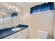 Bright bathroom with a white vanity, a large mirror, and blue countertop at 291 Miquel Jorge Ln, Canton, GA 30115