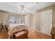 Bedroom features a white bed frame with a quilt, wood floors, a white door, and neutral walls at 291 Miquel Jorge Ln, Canton, GA 30115