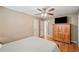 Bright bedroom featuring wood-look floors, a ceiling fan, and a wardrobe with storage at 291 Miquel Jorge Ln, Canton, GA 30115