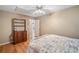 Bedroom features a white bed frame with a quilt, wood floors, white doors, and neutral walls at 291 Miquel Jorge Ln, Canton, GA 30115