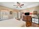 Bedroom features wood floors, ceiling fan, a large window, and a wooden dresser with a mounted TV at 291 Miquel Jorge Ln, Canton, GA 30115