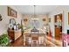 Traditional dining room with a wood table, upholstered chairs, wood floors, and natural light at 291 Miquel Jorge Ln, Canton, GA 30115