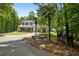 Charming home featuring a porte cochere, inviting front porch, and beautifully landscaped grounds at 291 Miquel Jorge Ln, Canton, GA 30115