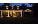 Inviting exterior of a home at night, featuring a cozy front porch and illuminated carport at 291 Miquel Jorge Ln, Canton, GA 30115