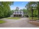 Charming home with a metal roof and a detached carport, nestled among mature trees at 291 Miquel Jorge Ln, Canton, GA 30115