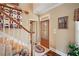Inviting foyer featuring a decorative front door, staircase, and stylish decor, creates a warm welcome at 291 Miquel Jorge Ln, Canton, GA 30115