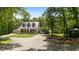 Charming home featuring a metal roof, covered porch, carport and a beautifully landscaped yard with mature trees at 291 Miquel Jorge Ln, Canton, GA 30115