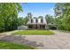 Charming home featuring a metal roof, covered porch, carport and a beautifully landscaped yard at 291 Miquel Jorge Ln, Canton, GA 30115