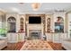 Inviting living room boasts a stone fireplace, custom built-ins, and hardwood floors for a cozy atmosphere at 291 Miquel Jorge Ln, Canton, GA 30115