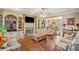 Cozy living room featuring a stone fireplace, built-in shelving, and hardwood floors, great for relaxation at 291 Miquel Jorge Ln, Canton, GA 30115