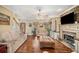 Open living area features hardwood floors, a stone fireplace, and cozy seating, blending comfort and style at 291 Miquel Jorge Ln, Canton, GA 30115