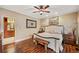 Charming main bedroom with wood floors, ceiling fan, large bed, bench, and ensuite bathroom at 291 Miquel Jorge Ln, Canton, GA 30115