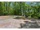 Parking area with a view of the house, surrounded by lush greenery and offering convenience for multiple vehicles at 291 Miquel Jorge Ln, Canton, GA 30115