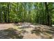 Spacious parking area surrounded by mature trees offering convenience and ample space for vehicles in a natural setting at 291 Miquel Jorge Ln, Canton, GA 30115