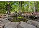 Scenic stone pond features natural waterfall and landscaping, creating a tranquil and picturesque outdoor retreat at 291 Miquel Jorge Ln, Canton, GA 30115
