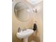 Elegant powder room with a pedestal sink and stylish sconce lighting at 291 Miquel Jorge Ln, Canton, GA 30115