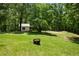 Expansive yard with mature trees and storage building, providing ample space and scenic views at 291 Miquel Jorge Ln, Canton, GA 30115