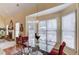 Breakfast nook with glass table, red chairs and access to the backyard at 905 Fairview Club Cir, Dacula, GA 30019