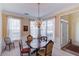 Formal dining room with a wood table, chandelier, and window seating at 905 Fairview Club Cir, Dacula, GA 30019