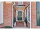 Green front door flanked by windows and stone lion statues at 905 Fairview Club Cir, Dacula, GA 30019