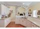 Kitchen with white cabinets, double sink, and view into living area at 905 Fairview Club Cir, Dacula, GA 30019